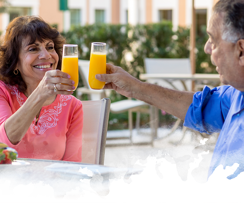 Couple toasting with mimosas