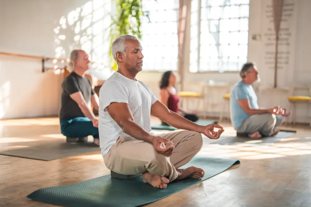 A group of seniors participating in guided meditation session