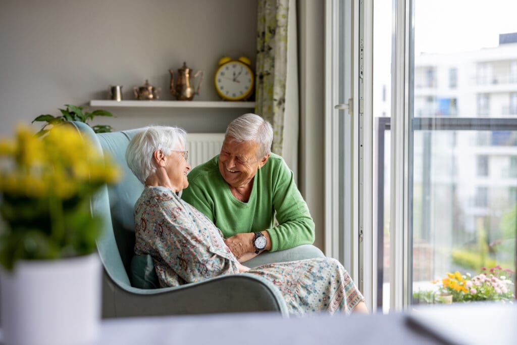 Senior couple sitting and laughing
